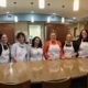 alt="TPTM team members posing for a photo in the kitchen of the Ronald McDonald House in Red Deer"