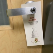 You've Been Elfed door hanger hanging on a door handle