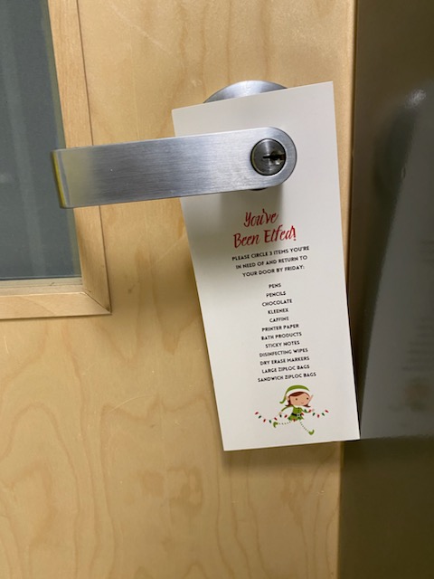 You've Been Elfed door hanger hanging on a door handle