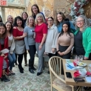 alt="Group of TPTM team members standing at a restaurant"